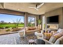 Bright and airy indoor patio featuring a fireplace and golf course views at 37200 N Cave Creek Rd # 1126, Scottsdale, AZ 85262