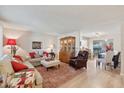Open concept living and dining area with hardwood floors at 10317 W Prairie Hills Cir, Sun City, AZ 85351