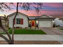 Charming house exterior with manicured lawn at sunset at 20428 W Elm Dr, Buckeye, AZ 85396