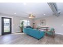 Modern living room with teal sofa and wood-look floors at 7544 E Mckinley St, Scottsdale, AZ 85257