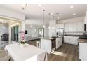 Modern kitchen with white cabinets, island, and stainless steel appliances at 15898 S 177Th Dr, Goodyear, AZ 85338