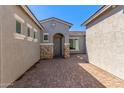 Inviting entryway with a stone accent wall and gray door at 15898 S 177Th Dr, Goodyear, AZ 85338