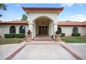 Inviting home exterior with a red tile roof and a landscaped front yard at 591 E Park Ave, Gilbert, AZ 85234