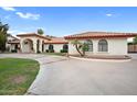Front view of a Spanish style home showcasing its landscaping and driveway at 591 E Park Ave, Gilbert, AZ 85234