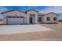 New single story home with a 3-car garage and desert landscaping at 2303 S 337Th Ave, Tonopah, AZ 85354
