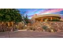 View of a luxury home's exterior entrance with stone facade and desert landscaping at 40523 N 102Nd Pl, Scottsdale, AZ 85262
