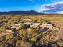 Aerial view of a luxury home nestled in a desert landscape with golf course views at 40523 N 102Nd Pl, Scottsdale, AZ 85262