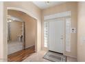 Bright entryway with tile flooring, wood-look flooring, and access to an office at 17828 W Mariposa Dr, Surprise, AZ 85374