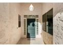 Covered entryway with teal door and glass block accents at 17828 W Mariposa Dr, Surprise, AZ 85374