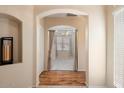 Hallway with hardwood floors leading to a bedroom with carpet at 17828 W Mariposa Dr, Surprise, AZ 85374