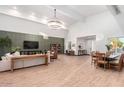 Open concept living room with a large sectional sofa and dining area at 3014 N 61St Pl, Scottsdale, AZ 85251