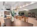 Elegant dining room with a large table and a modern chandelier at 3014 N 61St Pl, Scottsdale, AZ 85251