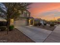 Two-story house with a two-car garage and desert landscaping at 30009 W Monterey Dr, Buckeye, AZ 85396