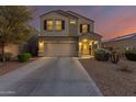 Two-story house with a two-car garage and desert landscaping at 30009 W Monterey Dr, Buckeye, AZ 85396
