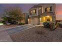 Two-story house with a two-car garage and desert landscaping at 30009 W Monterey Dr, Buckeye, AZ 85396