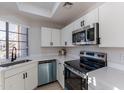 Modern kitchen featuring white cabinets, stainless steel appliances, and quartz countertops at 930 N Mesa Dr # 1039, Mesa, AZ 85201