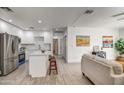 Modern kitchen with white cabinets, island, and stainless steel appliances at 3135 N 34Th St, Phoenix, AZ 85018