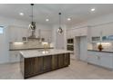 Modern kitchen with white cabinets, a large island, and geometric backsplash at 15528 E Chicory Dr, Fountain Hills, AZ 85268