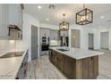 Modern kitchen with gray cabinets, white quartz countertops and stainless steel appliances at 15522 E Chicory Dr, Fountain Hills, AZ 85268