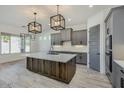 Modern kitchen featuring a large island, gray cabinets, and quartz countertops at 15522 E Chicory Dr, Fountain Hills, AZ 85268