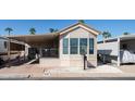 Mobile home with covered carport and front yard at 915 Mineshaft Dr, Apache Junction, AZ 85119