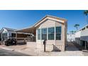 Mobile home with covered carport and front yard at 915 Mineshaft Dr, Apache Junction, AZ 85119