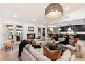Open living room showcasing comfortable seating, a fireplace, and views into the kitchen at 8014 E Del Tesoro Dr, Scottsdale, AZ 85258