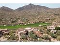 Luxury home on golf course with mountain views in the background at 9808 E Honey Mesquite Dr, Scottsdale, AZ 85262