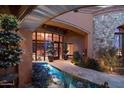 Elegant entryway with a serene water feature and lush landscaping at 9808 E Honey Mesquite Dr, Scottsdale, AZ 85262