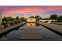 Relaxing pool area with fire pit and lounge chairs at sunset at 5815 N Kiva Ln, Paradise Valley, AZ 85253