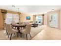 Bright dining room with seating for six and access to living room at 2754 W Tanner Ranch Rd, San Tan Valley, AZ 85144