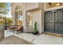Inviting front entry with decorative iron doors and a tranquil sitting area at 8757 E Lariat Ln, Scottsdale, AZ 85255