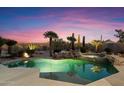 Inviting pool and spa surrounded by desert landscaping with mountain views at 34599 N 99Th Way, Scottsdale, AZ 85262
