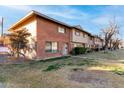 Tan brick townhome with grassy area and trees at 6742 N 43Rd Ave, Glendale, AZ 85301
