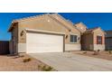 Tan house with white garage door and red shutters at 7010 E Drygulch Rd, San Tan Valley, AZ 85143