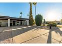 Single-story home with carport and desert landscaping at 3017 W Hearn Rd, Phoenix, AZ 85053
