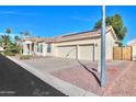 Beautiful home with three-car garage, mature landscaping, and a large driveway at 1223 E Clearview Dr, Casa Grande, AZ 85122