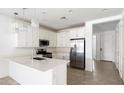 Modern kitchen with white cabinets, stainless steel appliances, and an island at 23075 E Orion Way, Queen Creek, AZ 85142