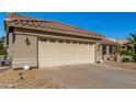 House exterior featuring a two-car garage and well-maintained landscaping at 14766 W Piccadilly Rd, Goodyear, AZ 85395