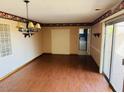 Spacious dining area with wood flooring and access to the patio at 10202 W Edgewood Dr, Sun City, AZ 85351
