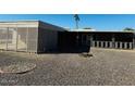 Large backyard with gravel and a screened patio area at 10202 W Edgewood Dr, Sun City, AZ 85351