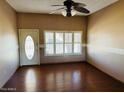 Bright living room with hardwood floors and a ceiling fan at 10202 W Edgewood Dr, Sun City, AZ 85351
