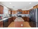 Eat-in kitchen with stainless steel appliances and an island at 3813 E Sierrita Rd, San Tan Valley, AZ 85143