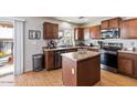 Spacious kitchen with an island, stainless steel appliances, and wood cabinets at 3813 E Sierrita Rd, San Tan Valley, AZ 85143