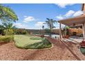 Relaxing backyard with a putting green, refreshing pool, and covered patio at 3813 E Sierrita Rd, San Tan Valley, AZ 85143
