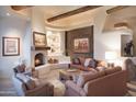 Living room with a cozy fireplace and natural light at 9215 E Red Lawrence Dr, Scottsdale, AZ 85262