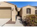 House exterior showcasing a walkway to the front door and attached two-car garage at 19034 W Yucatan Dr, Surprise, AZ 85388