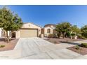 Two-story home with a two-car garage and landscaping at 19034 W Yucatan Dr, Surprise, AZ 85388