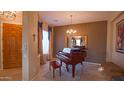Elegant living room with grand piano and entryway at 42715 N Courage Trl, Anthem, AZ 85086