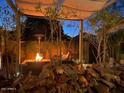 Relaxing backyard patio with fire pit and seating area at 42715 N Courage Trl, Anthem, AZ 85086